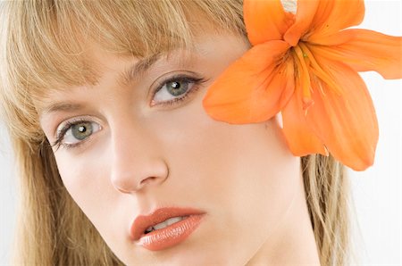 simsearch:400-06096871,k - nice clode up of a young pretty woman with an orange lily between hair Stock Photo - Budget Royalty-Free & Subscription, Code: 400-04034918