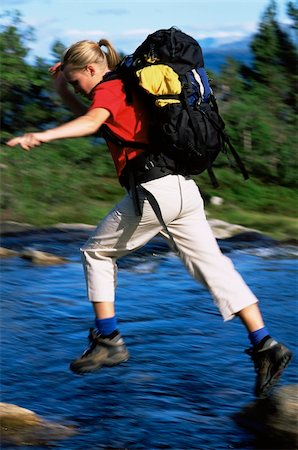 simsearch:632-05553953,k - Hiker jumping from rock to rock while crossing river Stock Photo - Budget Royalty-Free & Subscription, Code: 400-04034941