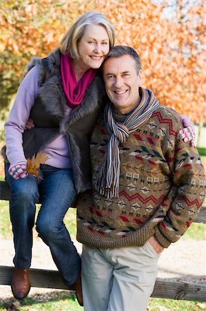 simsearch:400-05735475,k - Senior couple on autumn walk with trees in background Stock Photo - Budget Royalty-Free & Subscription, Code: 400-04035048