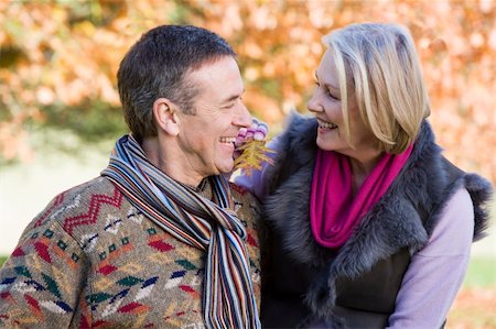 simsearch:400-05735475,k - Senior couple on autumn walk with trees in background Stock Photo - Budget Royalty-Free & Subscription, Code: 400-04035051