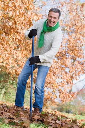 Senior man tidying autumn leaves in garden Stock Photo - Budget Royalty-Free & Subscription, Code: 400-04035061