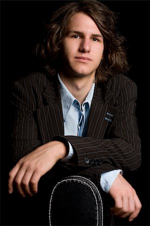 Early twentie male musician leaning on a guitar case Stock Photo - Budget Royalty-Free & Subscription, Code: 400-04035600