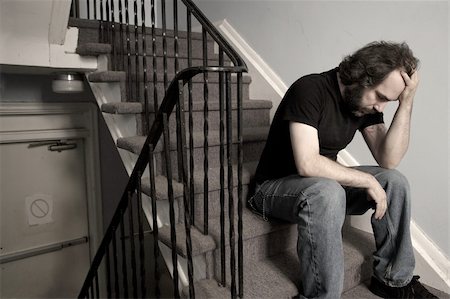 simsearch:400-04256583,k - A male adult with overwhelming depression sitting in the stairwell of his apartment building.  Desaturated. Foto de stock - Super Valor sin royalties y Suscripción, Código: 400-04035635