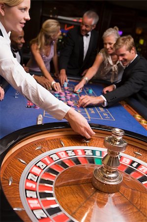 Group of friends gambling at roulette table in casino Stock Photo - Budget Royalty-Free & Subscription, Code: 400-04035657