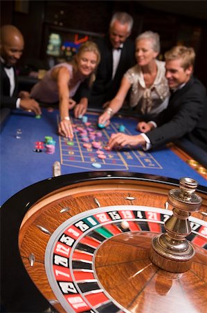 Group of friends gambling at roulette table in casino Stock Photo - Budget Royalty-Free & Subscription, Code: 400-04035659