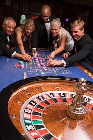 Group of friends gambling at roulette table Stock Photo - Budget Royalty-Free & Subscription, Code: 400-04035660