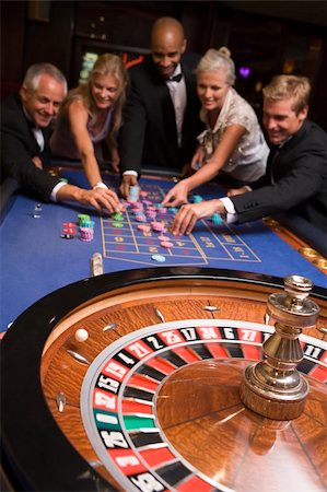 Group of friends gambling at roulette table in casino Stock Photo - Budget Royalty-Free & Subscription, Code: 400-04035661