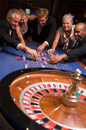 Group of friends gambling at roulette table in casino Stock Photo - Budget Royalty-Free & Subscription, Code: 400-04035662