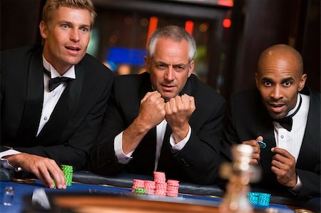 Group of male friends gambling at roulette table in casino Stock Photo - Budget Royalty-Free & Subscription, Code: 400-04035727