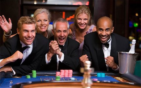 Group of friends celebrating win at roulette table in casino Stock Photo - Budget Royalty-Free & Subscription, Code: 400-04035730