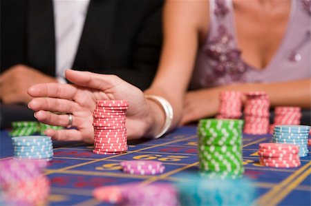 Close up of woman placing bet on roulette table in casino Stock Photo - Budget Royalty-Free & Subscription, Code: 400-04035742