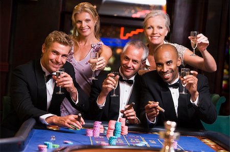 Group of friends gambling at roulette table in table Stock Photo - Budget Royalty-Free & Subscription, Code: 400-04035756