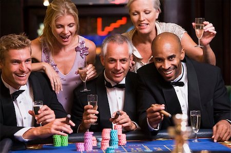 Group of friends gambling at roulette table in casino Stock Photo - Budget Royalty-Free & Subscription, Code: 400-04035757