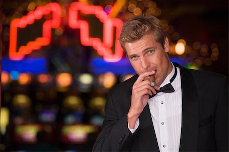 Man standing inside casino smoking cigar Stock Photo - Budget Royalty-Free & Subscription, Code: 400-04035768