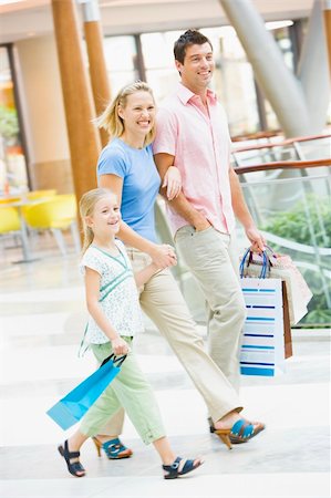 parent with credit card - Family shopping in mall carrying mall Stock Photo - Budget Royalty-Free & Subscription, Code: 400-04035946