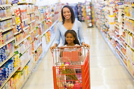 parents shopping trolley - Mother and daughter shopping for groceries in supermarket Stock Photo - Budget Royalty-Free & Subscription, Code: 400-04035993