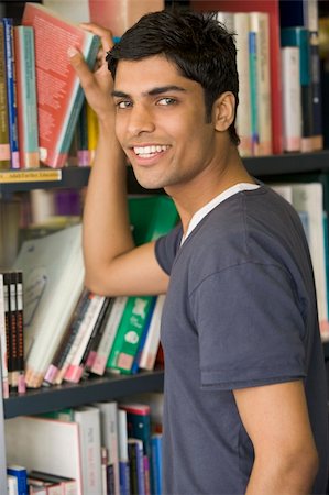 pakistani student - Male college student reaching for a library book Stock Photo - Budget Royalty-Free & Subscription, Code: 400-04036192