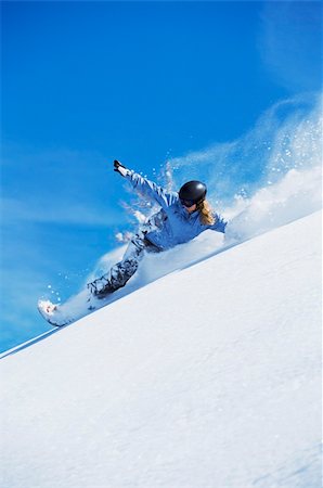 snowboarder powder snow - Young woman snowboarding Stock Photo - Budget Royalty-Free & Subscription, Code: 400-04036369