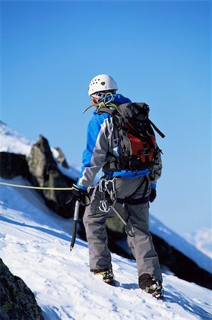 simsearch:400-04037283,k - Young man mountain climbing on snowy peak Stock Photo - Budget Royalty-Free & Subscription, Code: 400-04036384
