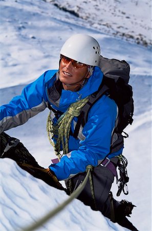 simsearch:400-04037283,k - Young man mountain climbing on snowy peak Stock Photo - Budget Royalty-Free & Subscription, Code: 400-04036386