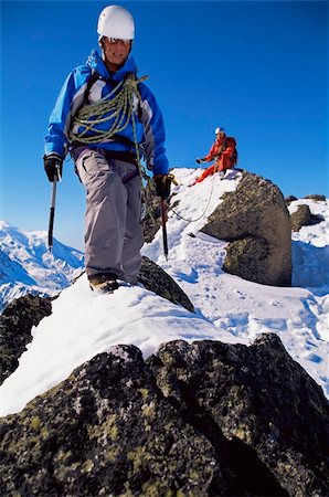 simsearch:400-04037283,k - Young men mountain climbing on snowy peak Stock Photo - Budget Royalty-Free & Subscription, Code: 400-04036381