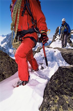 Young men mountain climbing on snowy peak Stock Photo - Budget Royalty-Free & Subscription, Code: 400-04036393