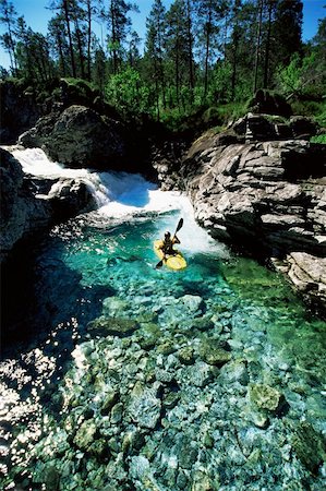 Young man kayaking in river Stock Photo - Budget Royalty-Free & Subscription, Code: 400-04036404