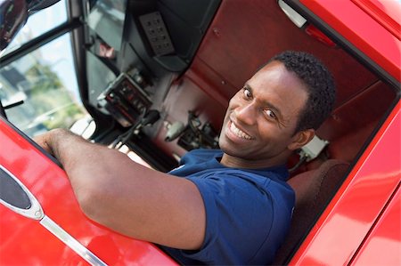 fireman driver pictures - A firefighter sitting in the cab of a fire engine Photographie de stock - Aubaine LD & Abonnement, Code: 400-04036434