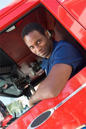 simsearch:400-04036456,k - A firefighter sitting in the cab of a fire engine Foto de stock - Royalty-Free Super Valor e Assinatura, Número: 400-04036435