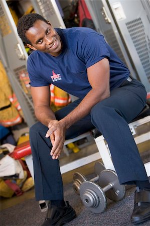 simsearch:400-04036456,k - Portrait of a firefighter in the fire station locker room Foto de stock - Royalty-Free Super Valor e Assinatura, Número: 400-04036446