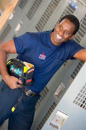 simsearch:400-04036456,k - Portrait of a firefighter in the fire station locker room Foto de stock - Royalty-Free Super Valor e Assinatura, Número: 400-04036443