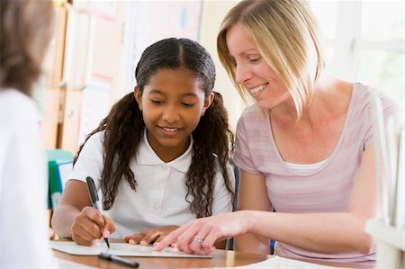 simsearch:400-04036581,k - A schoolgirl sitting with her teacher in class Stock Photo - Budget Royalty-Free & Subscription, Code: 400-04036514