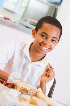 simsearch:400-04036581,k - Schoolboy enjoying his lunch in a school cafeteria Stock Photo - Budget Royalty-Free & Subscription, Code: 400-04036570