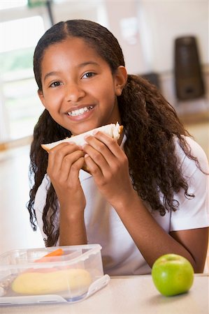 Schoolgirl enjoying her lunch in a school cafeteria Stock Photo - Budget Royalty-Free & Subscription, Code: 400-04036586