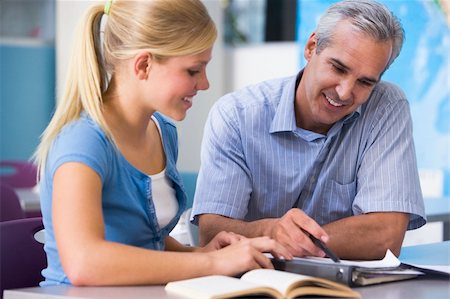 students reading book in classroom teen - A teacher instructs a schoolgirl in a high school class Stock Photo - Budget Royalty-Free & Subscription, Code: 400-04036652