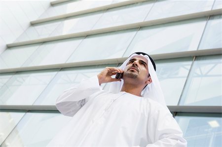 A Middle Eastern businessman talking on the phone outside an off Photographie de stock - Aubaine LD & Abonnement, Code: 400-04036998