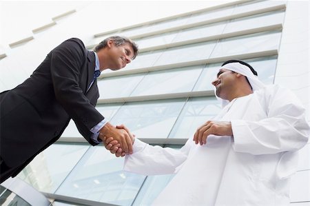 simsearch:400-04037075,k - A Middle Eastern businessman and Caucasian man shaking hands out Stock Photo - Budget Royalty-Free & Subscription, Code: 400-04037001