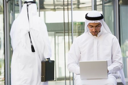 simsearch:400-04037075,k - A Middle Eastern businessman sitting with a laptop Stock Photo - Budget Royalty-Free & Subscription, Code: 400-04037016