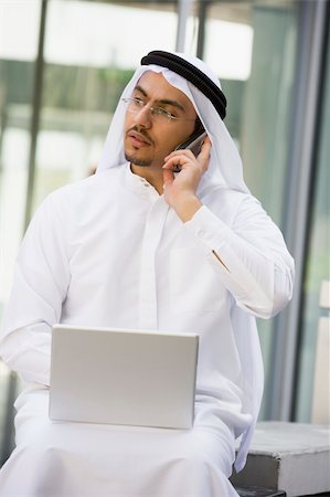 simsearch:400-04037075,k - A Middle Eastern businessman sitting with a laptop Stock Photo - Budget Royalty-Free & Subscription, Code: 400-04037017