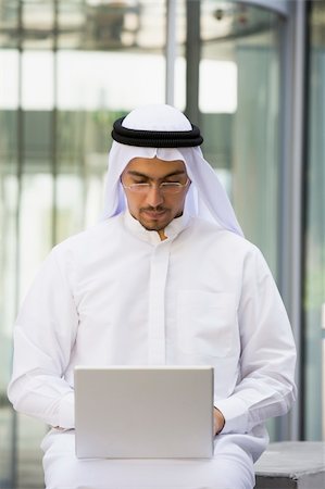 simsearch:400-04037075,k - A Middle Eastern businessman sitting with a laptop Stock Photo - Budget Royalty-Free & Subscription, Code: 400-04037018
