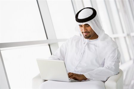 simsearch:400-04037075,k - A Middle Eastern businessman sitting with a laptop Stock Photo - Budget Royalty-Free & Subscription, Code: 400-04037049