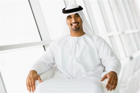 reception relaxed smile - A Middle Eastern businessman sitting in a chair Stock Photo - Budget Royalty-Free & Subscription, Code: 400-04037041