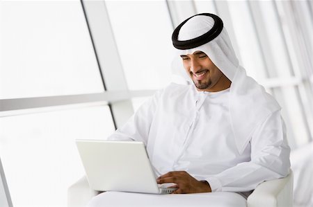 simsearch:400-04037075,k - A Middle Eastern businessman sitting with a laptop Stock Photo - Budget Royalty-Free & Subscription, Code: 400-04037050