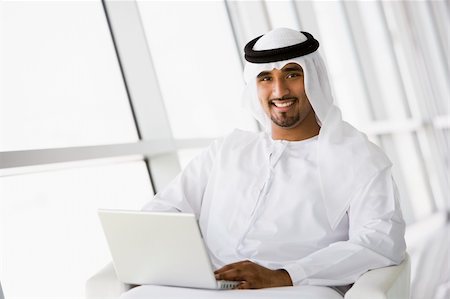 simsearch:400-04037075,k - A Middle Eastern businessman sitting with a laptop Stock Photo - Budget Royalty-Free & Subscription, Code: 400-04037051