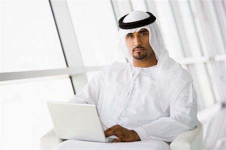 simsearch:400-04037075,k - A Middle Eastern businessman sitting with a laptop Stock Photo - Budget Royalty-Free & Subscription, Code: 400-04037052