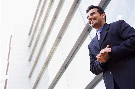 Businessman standing outside modern office building Stock Photo - Budget Royalty-Free & Subscription, Code: 400-04037109