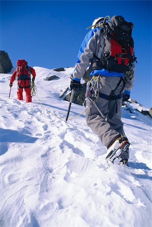 Young men mountain climbing on snowy peak Stock Photo - Budget Royalty-Free & Subscription, Code: 400-04037279