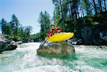 Kayaker perched on boulder in river Stock Photo - Budget Royalty-Free & Subscription, Code: 400-04037289