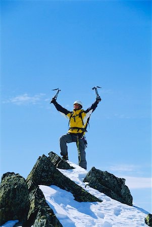 eispickel - Young man celebrating reaching the top of a mountain Stockbilder - Microstock & Abonnement, Bildnummer: 400-04037281