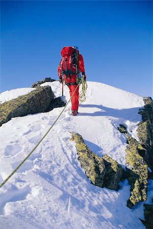 extreme sports and connect - Young man mountain climbing on snowy peak Stock Photo - Budget Royalty-Free & Subscription, Code: 400-04037283